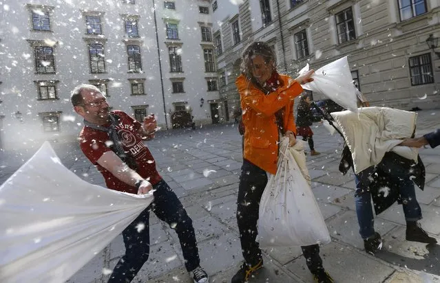 People fight with pillows during World Pillow Fight Day in Vienna, Austria, April 2, 2016. (Photo by Leonhard Foeger/Reuters)