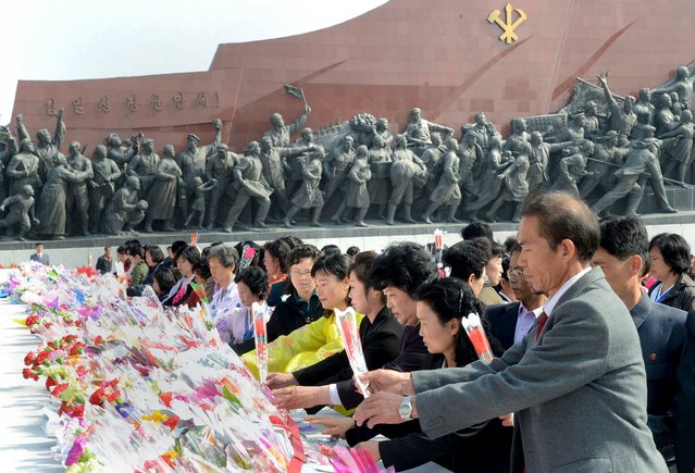 People visit the statues of North Korean founder Kim Il Sung and his son, former leader Kim Jong Il, on the anniversary of the birth of Kim Il Sung, in this undated photo released by North Korea's Korean Central News Agency (KCNA) in Pyongyang April 15, 2016. (Photo by Reuters/KCNA)
