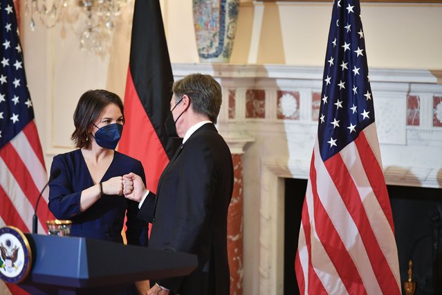 German Foreign Minister Annalena Baerbock fist bumps with Secretary of State Antony Blinken at the State Department, Wednesday, January 5, 2022, in Washington. The United States and Germany said Wednesday that Russia’s military buildup near Ukraine’s border poses an “immediate and urgent challenge” to European security and that any intervention will draw severe consequences. But the country's top diplomats left open what those consequences would be and how differences on arming Ukraine and a controversial Russian gas pipeline will be resolved. (Photo by Mandel Ngan/Pool via AP Photo)