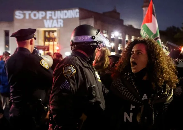 A police officer detains a protester after blocking a street during a protest demanding the U.S. government to stop arming Israel, during the ongoing conflict between Israel and the Palestinian Islamist group Hamas, in Brooklyn, New York City April 23, 2024. (Photo by Jim Urquhart/Reuters)