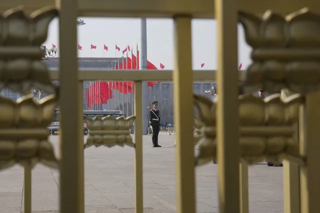 In this Friday, March 3, 2017 photo, a Chinese paramilitary policeman stands on duty near the Great Hall of the People in Beijing, China. (Photo by Ng Han Guan/AP Photo)