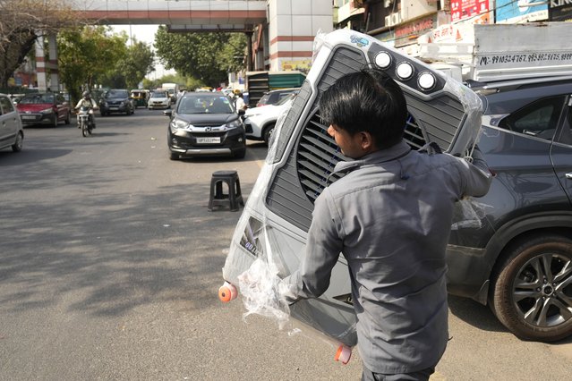 A man carries a water cooler for his home as temperatures rise in New Delhi, India, Monday, May 27, 2024. (Photo by Manish Swarup/AP Photo)