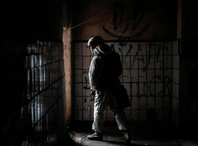 A Ukrainian service member walks on the front line at the industrial zone of government-held town of Avdiyivka in Donetsk region, Ukraine on February 9, 2022. (Photo by Gleb Garanich/Reuters)