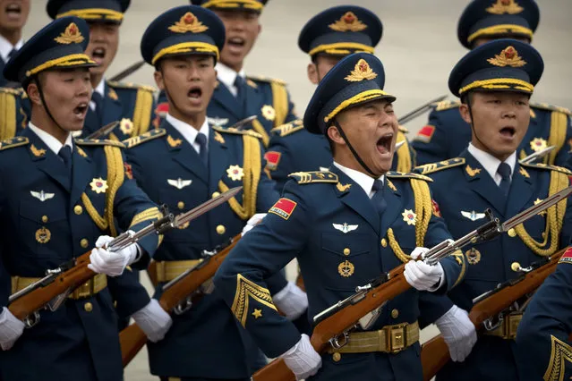 Members of a Chinese honor guard let out a yell as they march in formation during a welcome ceremony for Serbian President Tomislav Nikolic at the Great Hall of the People in Beijing, Thursday, March 30, 2017. (Photo by Mark Schiefelbein/AP Photo)