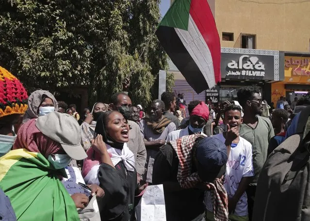 People protest against last year's military coup, in Khartoum, Sudan, Monday, February 14, 2022. Sudan’s military authorities arrested Mohammed al-Faki Suliman, a former senior government official, for a second time, his party said, as thousands of people took to the streets around the country Monday to protest an October military coup. (Photo by AP Photo/Stringer)