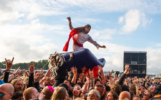 A fan dressed as Jesus crowd surfs during the Download PILOT festival at Donington Park on June 20, 2021 in Donington, England. Download Pilot is a 10,000 capacity festival part of a UK government test event to examine how Covid-19 transmission takes place in crowds. (Photo by Katja Ogrin/Getty Images)