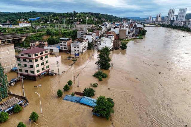 This photo taken on June 29, 2024 shows an aerial view of flooded buildings after a flood peak on the Wuyang river at Qiandongnan, in China's southwest Guizhou province. (Photo by AFP Photo/China Stringer Network)