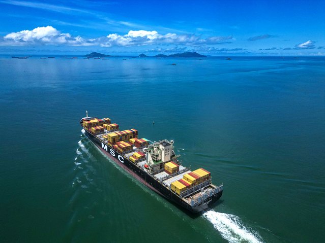 A cargo ship leaves the Panama Canal in Panama City on June 17, 2024. The Panama Canal will once again increase the number of ships transiting its waters daily, Panama Canal authorities said on June 18, 2024. The canal is gradually approaching the volume of vessels it received before 2023, the year in which it suffered a water shortage crisis. (Photo by Martin Bernetti/AFP Photo)