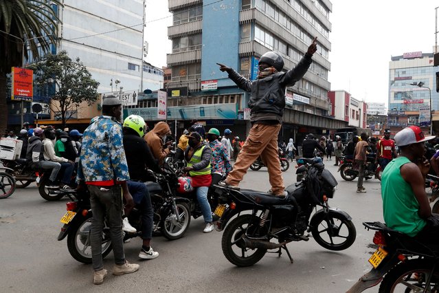 A person stands on a motorbike as pro-government protesters parade to counter an anti-government demonstration, following nationwide deadly riots over tax hikes, in Nairobi, Kenya on July 23, 2024. (Photo by Thomas Mukoya/Reuters)