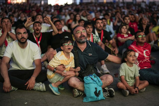 Turkish supporters celebrate a goal as they watch a Group F match between Turkey and Georgia at the Euro 2024 soccer tournament being played in Dortmund, Germany, Tuesday, June 18, 2024 in Kadikoy district in Istanbul. (Photo by Francisco Seco/AP Photo)