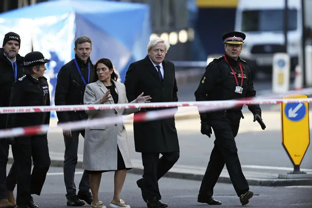 Britain's Prime Minister Boris Johnson, second right, Home Secretary Priti Patel, center, and Metropolitan Police Commissioner, Cressida Dick, left, attend the scene in central London, Saturday, November 30, 2019, after an attack on London Bridge on Friday. UK counterterrorism police on Saturday searched for clues into how a man imprisoned for terrorism offenses before his release last year managed to stab several people before being tackled by bystanders and shot dead by officers on London Bridge. Two people were killed and three wounded. (Photo by Steve Parsons/PA Wire via AP Photo)
