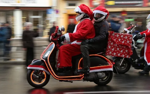 Motorcycle enthusiasts dressed as Santa Claus ride in the 22nd “Berlin Christmas Biketour” on December 14, 2019 in Berlin, Germany. Around one hundred motorcyclists dressed as Santa Claus, reindeer and angels rode motorcycles decorated with Christmas lights across the city in an annual fundraiser for the needy. (Photo by Adam Berry/Getty Images)