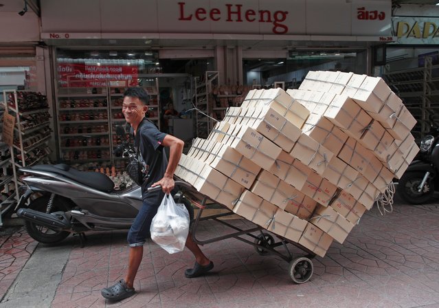 A worker pulls a cart loaded with goods for sale at a market in Chinatown, Bangkok, Thailand, 20 August 2024. Thailand's Gross Domestic Product (GDP) figures expanded by 2.3 percent in the second quarter after accelerating from a 1.6 percent growth in the first quarter of 2024. The growth was driven by stronger private consumption, government consumption, tourism and exports while the country's economic outlook for the entire 2024 is forecasted to grow by 2.3 to 2.8 percent with a median estimate of 2.5 percent, according to Danucha Pichayanan, the Secretary-general of the National Economic and Social Development Council (NESDC), the Thai government's planning agency. (Photo by Rungroj Yongrit/EPA/EFE)