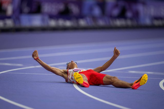 Yassine Ouhdadi El Ataby, of Spain, celebrates after winning at Men's 5000m - T13 final at the Stade de France stadium, during the 2024 Paralympics, Saturday, August 31, 2024, in Paris, France. (Photo by Emilio Morenatti/AP Photo)