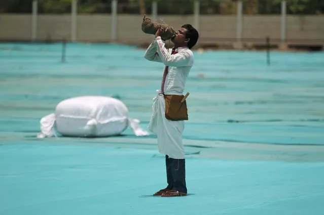 A man drinks water at one of the venues of a yoga camp ahead of World Yoga Day in Ahmedabad, India, June 15, 2016. (Photo by Amit Dave/Reuters)