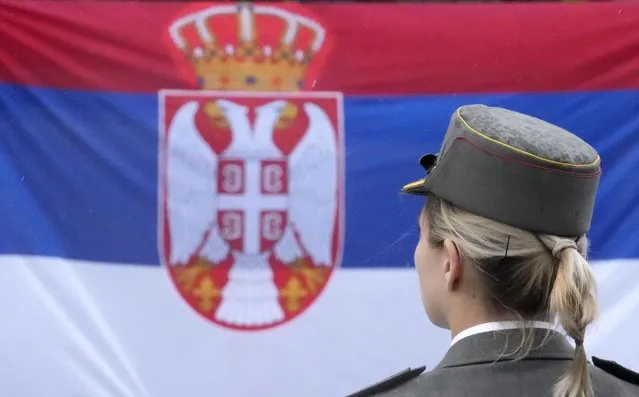 A member of the Serbian honour guard stands by a Serbian flag in front of the Parliament building, during Serbia's President Aleksandar Vucic inauguration for a second term, in Belgrade, Serbia, Tuesday, May 31, 2022. Vucic was inaugurated Tuesday for his second term as Serbia's president, saying the Balkan country will remain on its European Union membership path and hinted that a new government might consider joining Western sanctions against ally Russia over the war in Ukraine. (Photo by Darko Vojinovic/AP Photo)