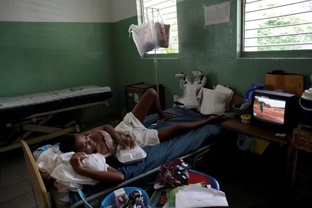 Mirlene Verdieu watches television as she rests in a room at the Hospital of the State University of Haiti, which is one of the centers affected by a three-month-long strike by health workers demanding a pay rise and resources, in Port-au-Prince, Haiti, June 20, 2016. (Photo by Andres Martinez Casares/Reuters)