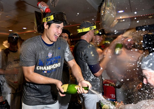 Los Angeles Dodgers designated hitter Shohei Ohtani celebrates with champagne in the clubhouse after defeating the New York Mets in game six of the NLCS for the 2024 MLB playoffs at Dodger Stadium on October 21, 2024. (Photo by Jayne Kamin-Oncea/Imagn Images via Reuters)