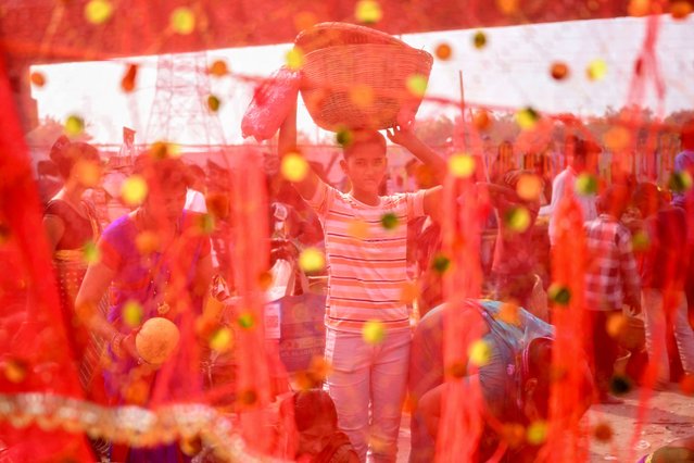 People buy items that are used as religious offerings ahead of the Hindu Chhath Puja festival at a market in New Delhi on November 6, 2024. (Photo by Sajjad Hussain/AFP Photo)