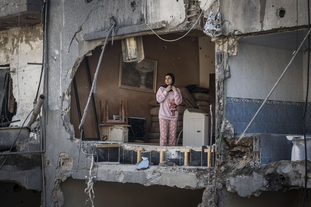 A young Lebanese girl is seen inside her house, which was heavily damaged and some of its walls collapsed in the attack carried out by the Israeli army yesterday in Sidon, Lebanon on October 30, 2024. While the houses in the area were damaged as a result of the attack, it was reported that there were dead and injured people in the attack. (Photo by Murat Sengul/Anadolu via Getty Images)