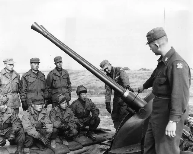 1st Lieutenant Henry Pugh taking a class in the operation of a 40mm gun at a Korean training area, 17th March 1954. (Photo by Evans)