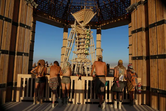 Participants look at the Man as approximately 70,000 people from all over the world gathered for the annual Burning Man arts and music festival in the Black Rock Desert of Nevada, U.S. August 29, 2017. (Photo by Jim Urquhart/Reuters)