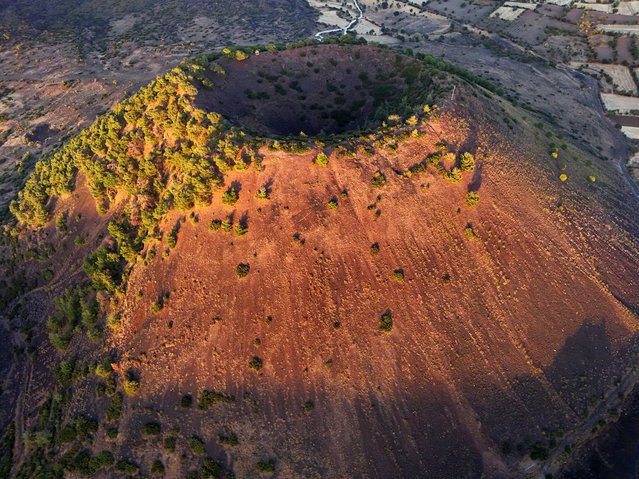 Aerial view of the Kula-Salihli Geopark, known for its volcanic hills and lava-formed 'rock sea,' where scientists discovered eight magma chambers at different depths beneath the Earth's crust in Manisa's Kula district, home to Turkiye's youngest volcanoes on October 4, 2024. Scientists have identified the largest, near-surface magma chamber as posing a potential eruption risk due to factors such as earthquakes. Mentioned by ancient historian Strabo in his work 'Geographika' as 'Katakekaumene' (Burnt Land), the UNESCO-listed site is known for its historical heritage, natural beauty, and hot springs, serving as a natural laboratory for scientists. (Photo by Berkan Cetin/Anadolu via Getty Images)