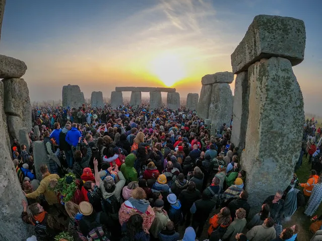 People gather for sunrise at Stonehenge, on June 21, 2022 in Wiltshire, England. The summer solstice occurs on June 21st, it is the longest day and shortest night of the year in the Northern Hemisphere. The 2022 summer solstice arrives at 5:14 a.m. (Photo by Finnbarr Webster/Getty Images)