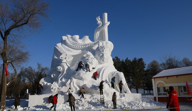 Sculptors carve a snow sculpture with the character Monkey King from the Chinese game “Black Myth: Wukong” as the model sample at the 37th Harbin Sun Island International Snow Sculpture Art Expo on December 11, 2024 in Harbin, Heilongjiang Province of China. (Photo by VCG/VCG via Getty Images)