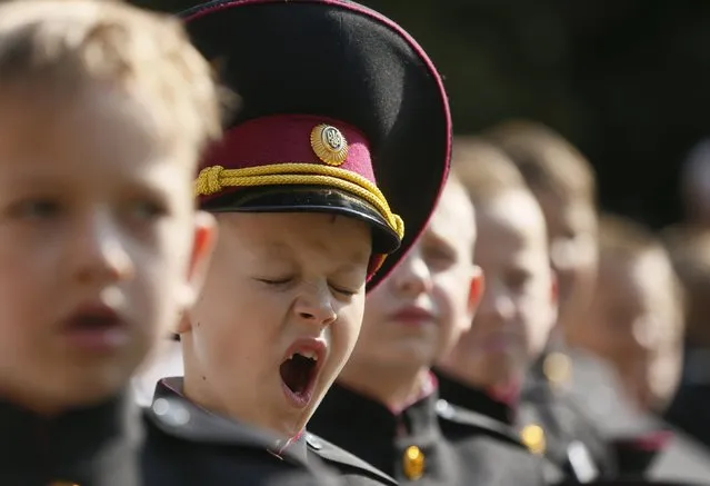 A first grader of a cadet's lyceum yawns as he attends a ceremony to mark the start of the new school year in Kiev, Ukraine, September 1, 2015. (Photo by Valentyn Ogirenko/Reuters)