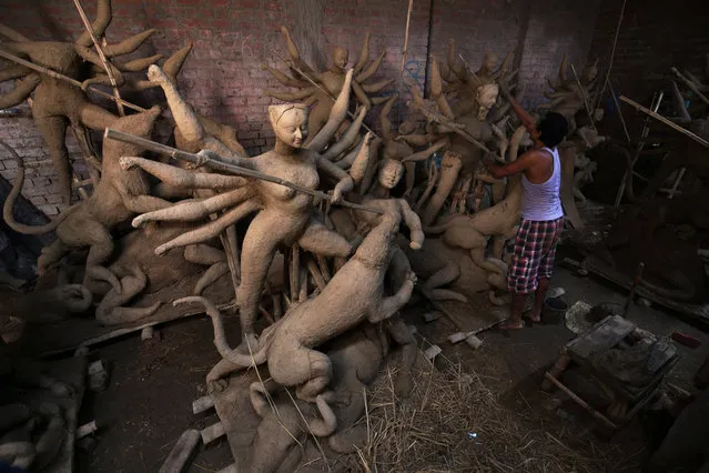 Bengali Indian artist Shiv Kumar works on making clay idols of Goddess Durga at his home workshop for sale ahead of the Durga Puja festival in Amritsar, India, 11 September 2017. Bengalis all over the world will be marking the Durga Puja festival, representing the victory of good over evil and the celebration of female power, from 26 to 30 September 2017. (Photo by Raminder Pal Singh/EPA/EFE)