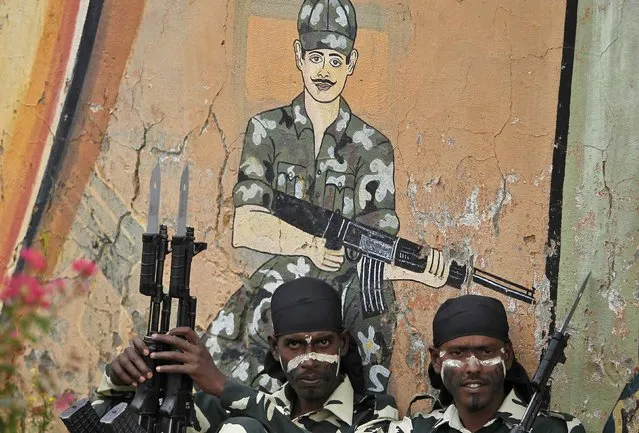 India's Central Reserve Police Force (CRPF) personnel sit before taking part in the passing out parade in Humhama, on the outskirts of Srinagar August 28, 2014. According to authorities from CRPF, 368 new policemen were formally inducted into the force after completing a 44-week rigorous training course and will be deployed in different parts of India. (Photo by Danish Ismail/Reuters)