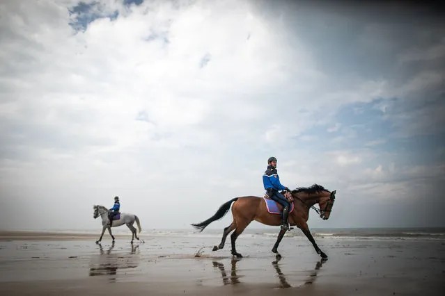 French Gardes Republicains mounted gendarmes patrol on the beach of Courseulles-sur-Mer, Normandy, on April 17, 2020, on the 32nd day of a strict lockdown in France aimed at curbing the spread of the COVID-19 infection caused by the novel coronavirus. (Photo by Lou Benoist/AFP Photo)