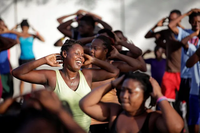 Residents exercise during a group workout at a public park in Port-au-Prince, Haiti July 28, 2016. (Photo by Andres Martinez Casares/Reuters)