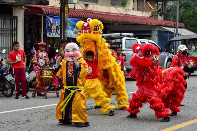 School children take part in a traditional lion dance to celebrate the upcoming lunar new year in the southern Thai province of Narathiwat on January 25, 2025. (Photo by Madaree Tohlala/AFP Photo)