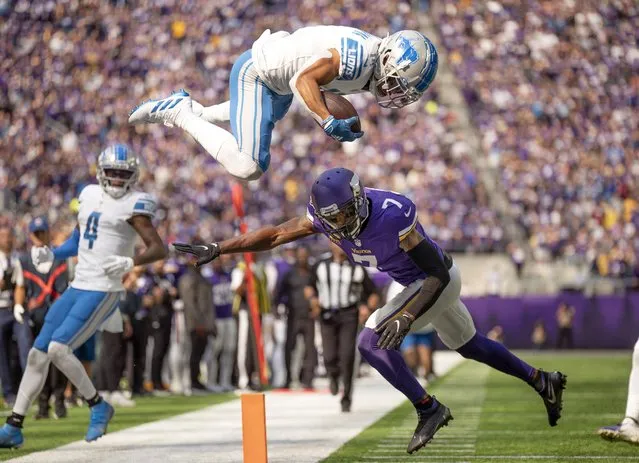 Detroit Lions wide receiver Amon-Ra St. Brown, top, leaps over Minnesota Vikings cornerback Patrick Peterson (7) while picking up a first down at the 2-yard line in the first quarter of an NFL football game in Minneapolis, Sunday, September 25, 2022. (Photo by Jerry Holt/Star Tribune via AP Photo)