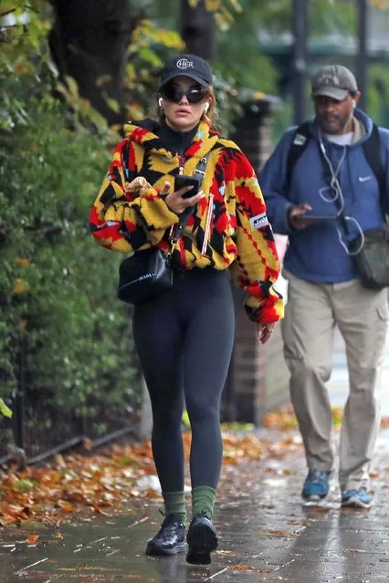 Rita Ora puts on a very snazzy display in a colourful zip-up fleece during outing in London on October 21, 2022. The singer, 31, put on an unmissable display in a colourful zip-up fleece and black leggings while wearing wraparound sunglasses and a black baseball cap. She accessorised her look with a leather Prada bag and sported charcoal trainers, which she wore with khaki socks. (Photo by The Mega Agency)