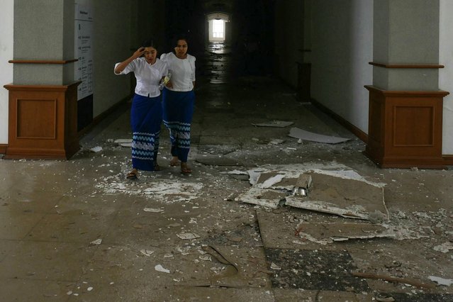 Women walk past debris in the National Museum in Naypyidaw on March 28, 2025, after an earthquake in central Myanmar. (Photo by Sai Aung Main/AFP Photo)