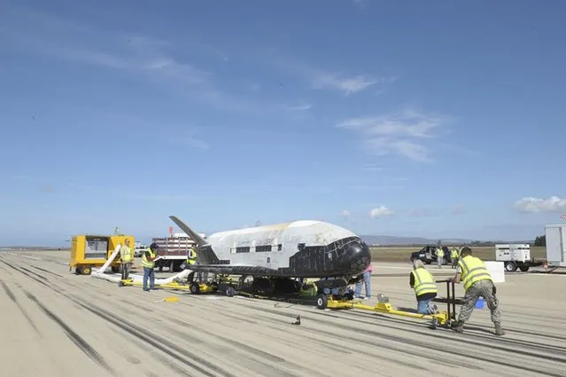 The X-37B Orbital Test Vehicle mission 3 space plane is shown after landing at Vandenberg Air Force Base, California October 17, 2014 in this handout photograph provided by Vandenberg Air Force Base. The United States military landed the robotic space plane in central California on Friday, ending a classified 22-month mission that marked the third in Earth orbit for the experimental program, the Air Force said. (Photo by Reuters/Boeing/Vandenberg Air Force Base)