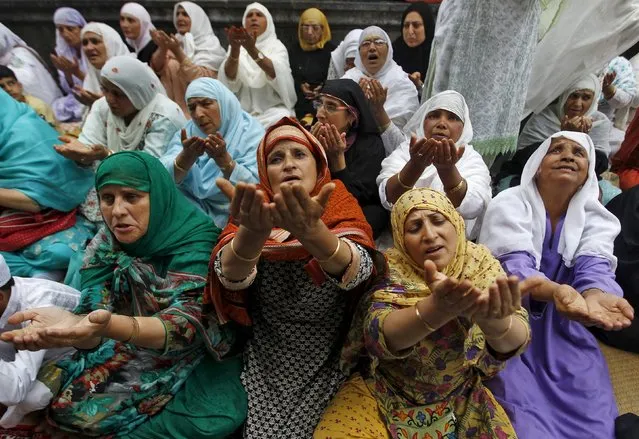 Kashmiri Muslim women raise their hands as they pray at the shrine of Mir Syed Ali Hamdani, a Sufi saint, during a religious festival to mark Saint Hamdani's birth anniversary in Srinagar September 21, 2015. (Photo by Danish Ismail/Reuters)