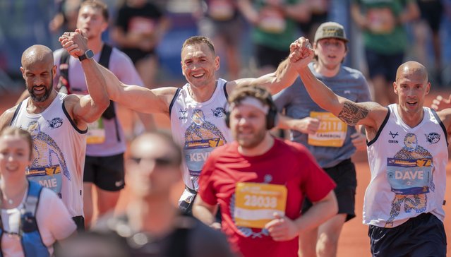 Kevin Sinfield (centre) with, Jamie Jones-Buchanan (left) and Dave Spencer (right) as the cross the finish line during of the Rob Burrow Leeds Marathon, Relay, and MND Mile in Leeds, UK on Sunday, May 11, 2025. (Photo by Danny Lawson/PA Wire)