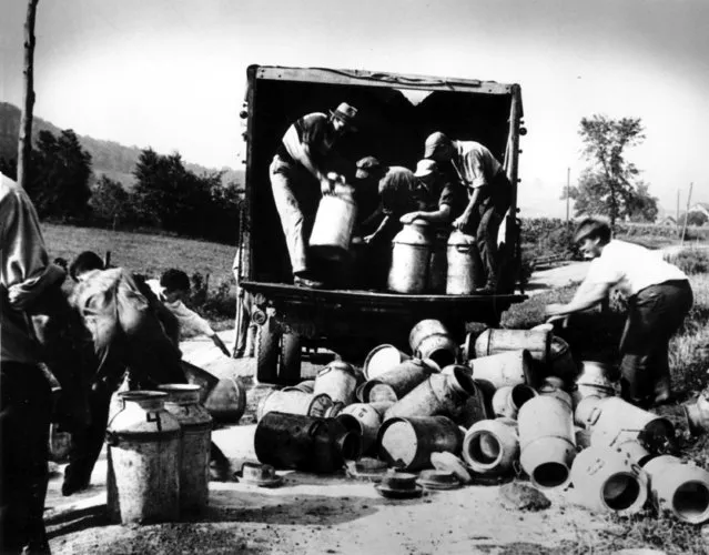 Striking upstate dairy farmers dump milk from a truck near Mount Upton, N.Y., on August 18, 1939 during the Great Depression. (Photo by AP Photo)