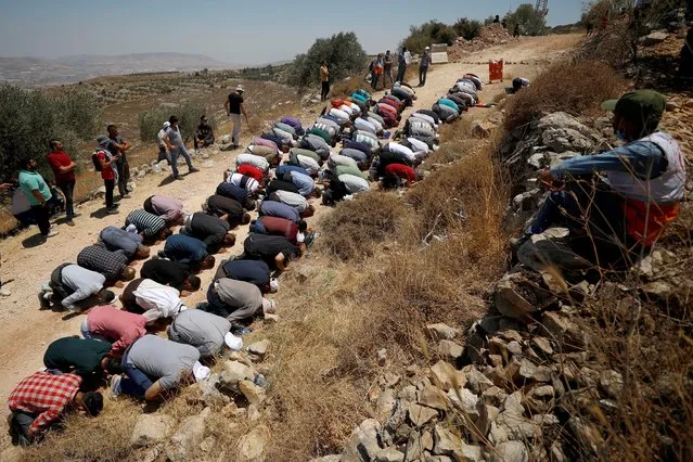 Palestinians attend Friday prayers during a protest against Jewish settlements and Israel's planned annexation of parts of the Israeli-occupied West Bank, in the Palestinian town of Asira ash-Shamaliya on July 17, 2020. (Photo by Mohamad Torokman/Reuters)