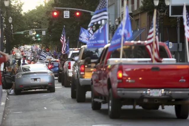 A caravan of supporters of President Donald Trump drive in downtown Portland, Ore., Saturday, August 29, 2020. Saturday's rally was the third consecutive weekend that pro-Trump demonstrators converged in and around Portland, leading to clashes with counter protesters. (Photo by Dave Killen/The Oregonian via AP Photo)