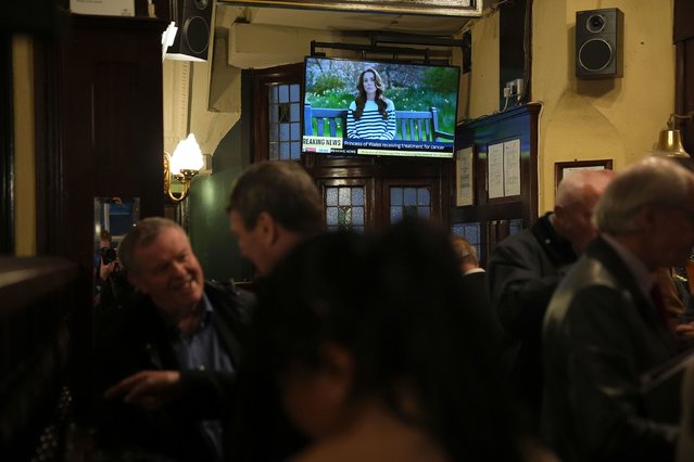 People watch a broadcast of an announcement by the Princess of Wales, in the Westminster Arms public house in Westminster on Friday, March 22, 2024. The Princess of Wales has revealed she is undergoing chemotherapy treatment for cancer. She announced the news in a pre-recorded message that was broadcast on Friday evening. (Photo by Aaron Chown/AP Photo)