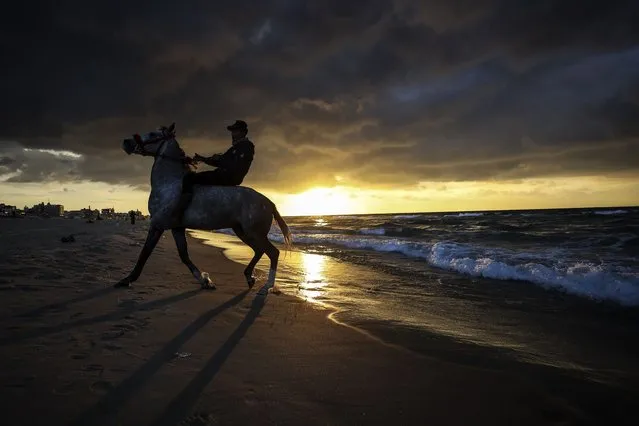 A Palestinian youth is riding his horse during sunset in front of Gaza Beach, Gaza, Palestine, on January 5, 2023. (Photo by Sameh Rahmi/NurPhoto via Getty Images)