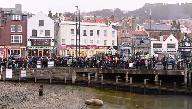 Crowds gather to see an Atlantic Walrus resting on a harbour slipway on New Years Eve in Scarborough, North Yorkshire, England on December 31, 2022. (Photo by Will Palmer/SWpix.com/Rex Features/Shutterstock)