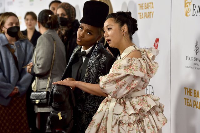 Actress Stephanie Hsu, right, pretends to pet the dog-shaped purse carried by Janelle Monae, left, at the 2023 BAFTA Tea Party, Saturday, January 14, 2023, at the Four Seasons Hotel Los Angeles at Beverly Hills, in Los Angeles. (Photo by Jordan Strauss/Invision/AP Photo)