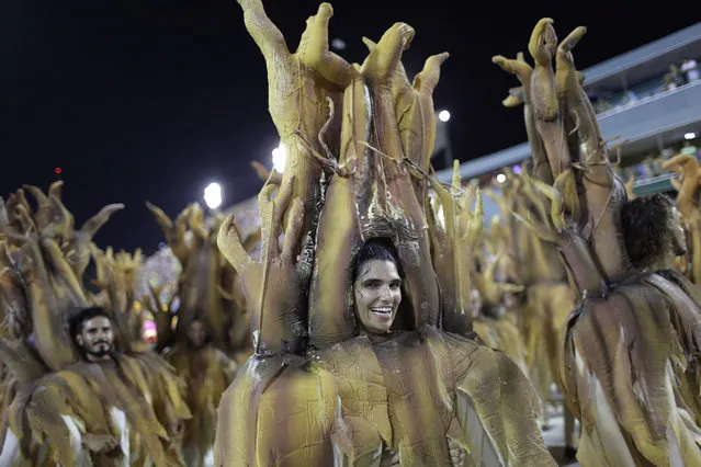 Performers from the Sao Clemente samba school parade during Carnival celebrations at the Sambadrome in Rio de Janeiro, Brazil, Sunday, February 11, 2018. (Photo by Silvia Izquierdo/AP Photo)