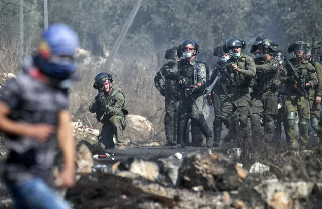 Israeli security forces take position during clashes with Palestinian protesters at a weekly demonstration in the village of Kfar Qaddum in the occupied West Bank, on October 2, 2020. (Photo by Jaafar Ashtiyeh/AFP Photo)